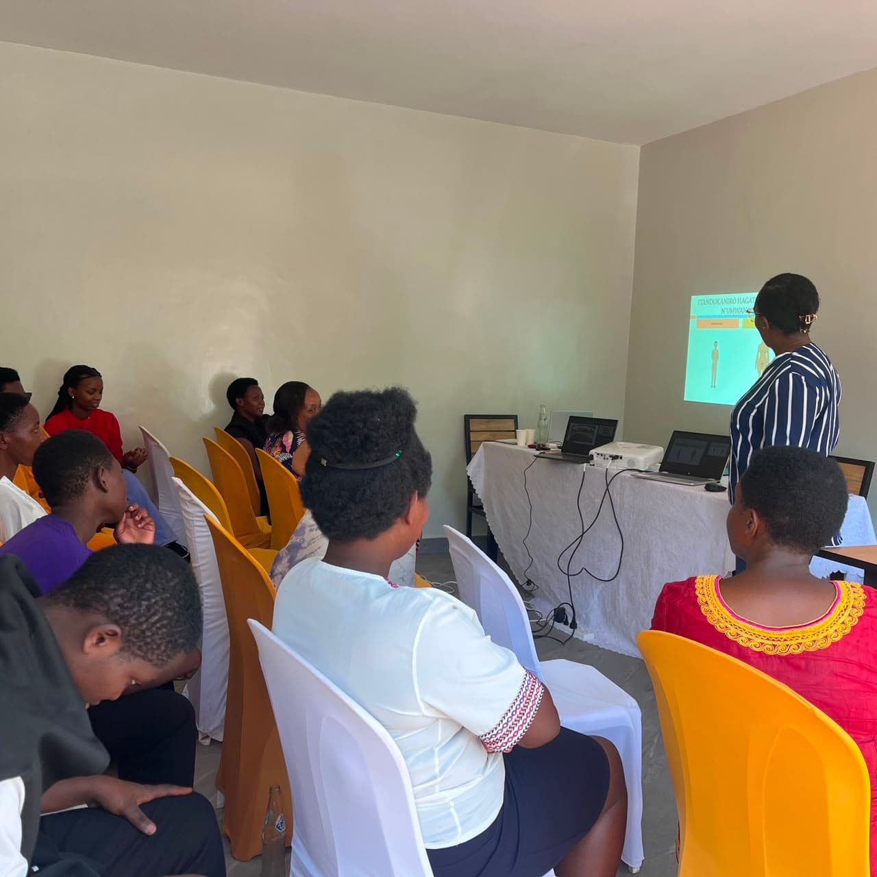 Participants follow a projected slide on caregiving during the training session